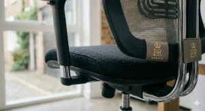 Detailed view of durable grey fabric upholstery on a high-back drafting chair, highlighting the premium finish and cushioned seat padding.