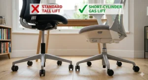 Alt text for image 7: A detailed comparison view set near the wooden floor, focusing sharply on the gas lift mechanisms. Two chairs are positioned side-by-side: a standard chair on the left has a 'Standard Tall Lift' red marker, and the specialized chair from the previous images on the right has a clear green marker pointing to its 'Short-Cylinder Gas Lift', which allows the seat to be set much lower.