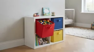 A low cube storage unit organised with colourful toy bins in a children's bedroom in the UK.