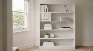 A clean white minimalist office bookcase positioned against a neutral grey wall.