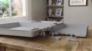 A side-by-side comparison showing how stackable letter trays reduce desk clutter compared to flat filing.